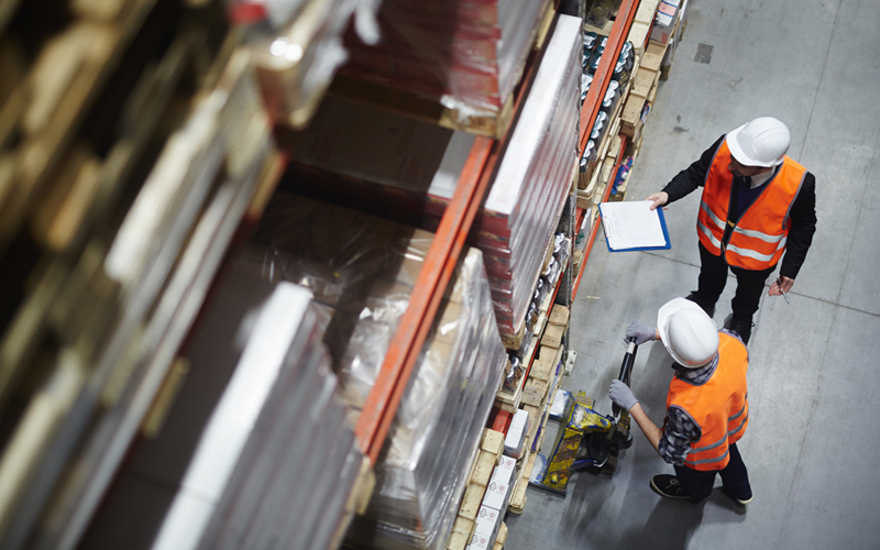 Warehouse workers checking stock on shelves