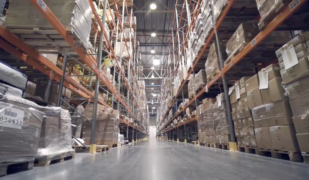 Photo of a warehouse with shelves full of stock